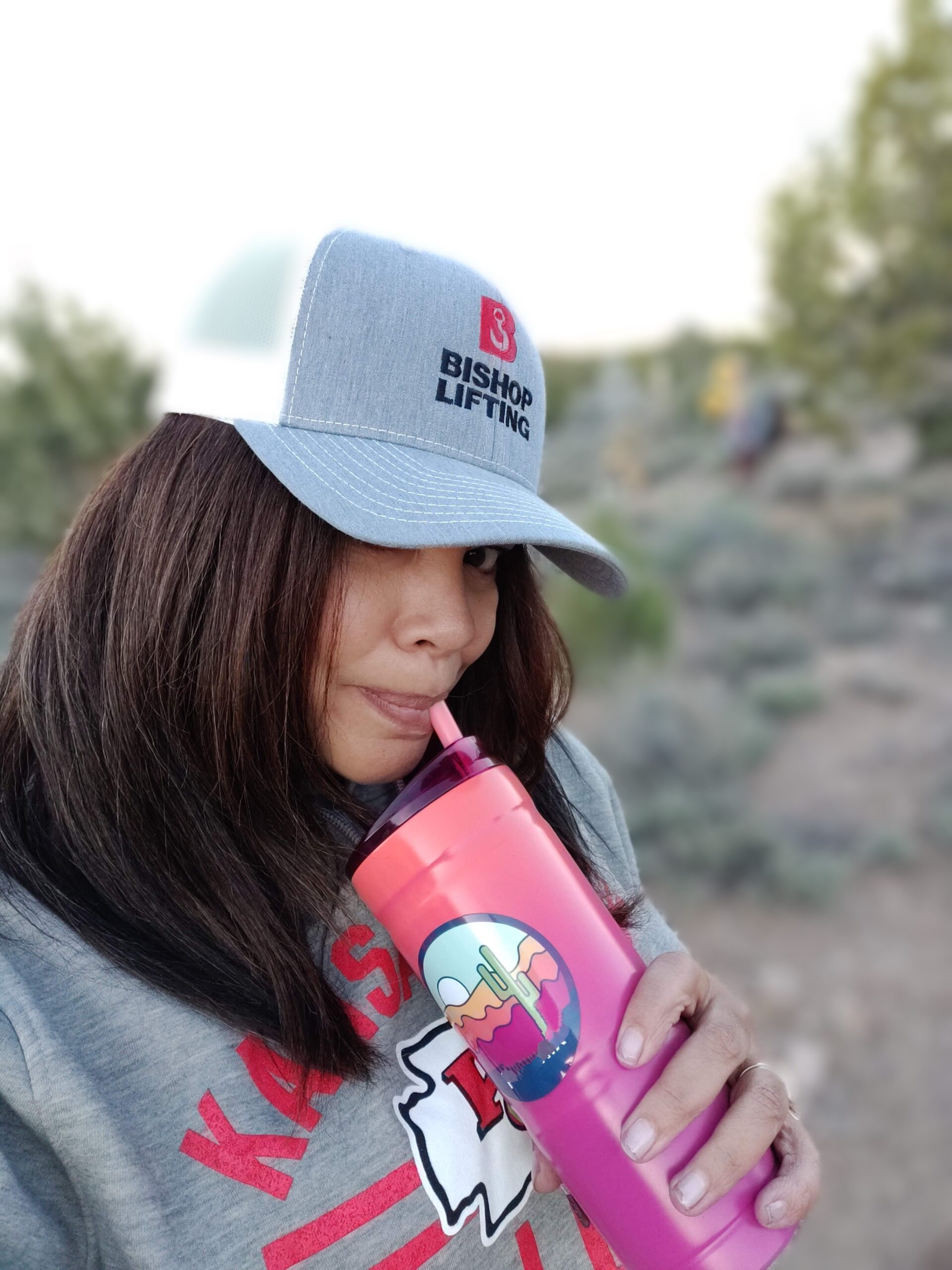 woman enjoying a drink outdoors using Bubba insulated tumbler – best outdoor gear for women