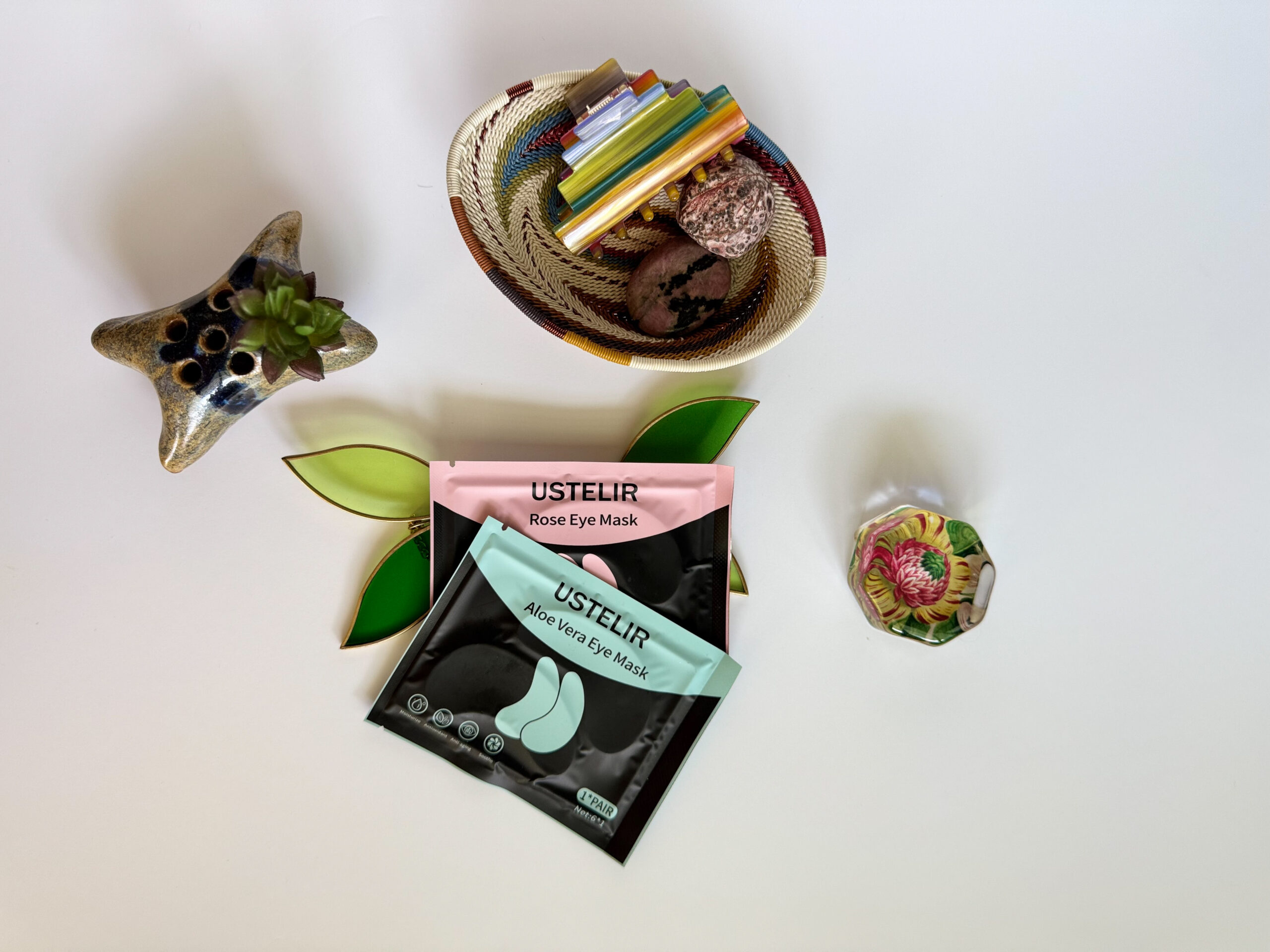 Close-up of Ustelir under-eye patch packets styled for a calming morning self-care routine.