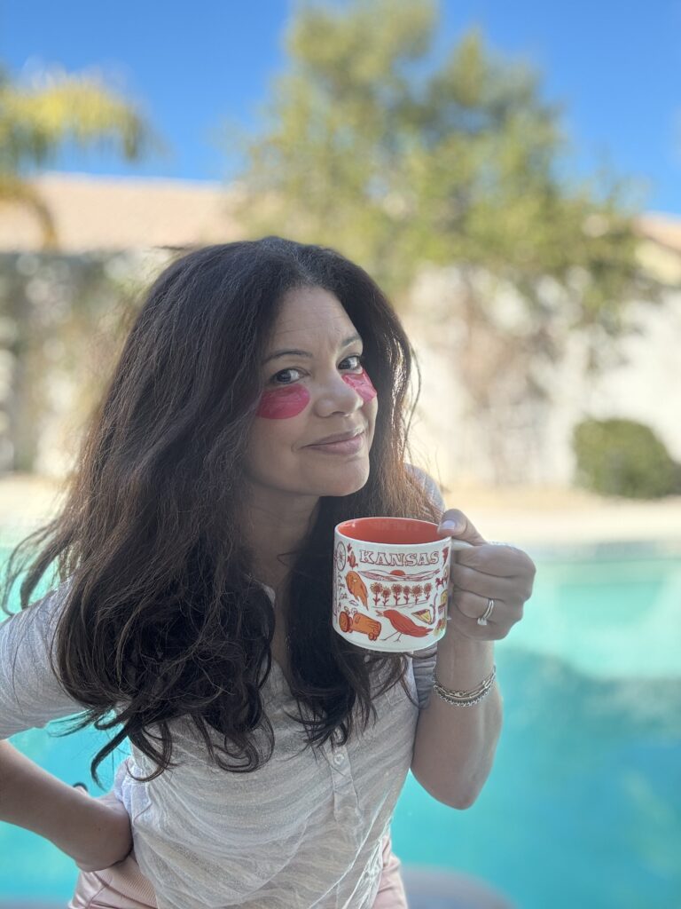 black mature woman wearing eye masks holding coffee mug