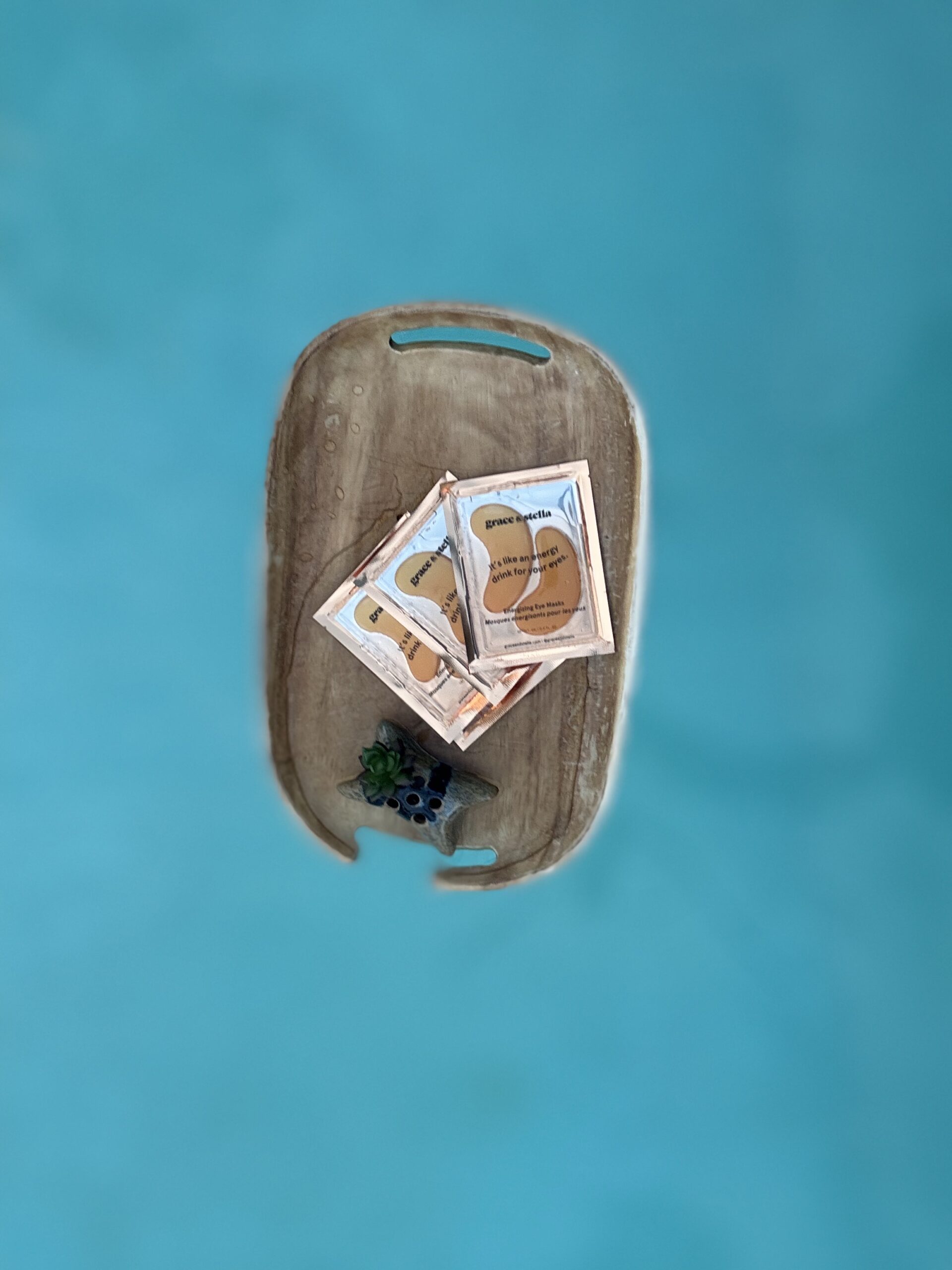 eye patches for puffy eyes on tray floating in blue water of a pool