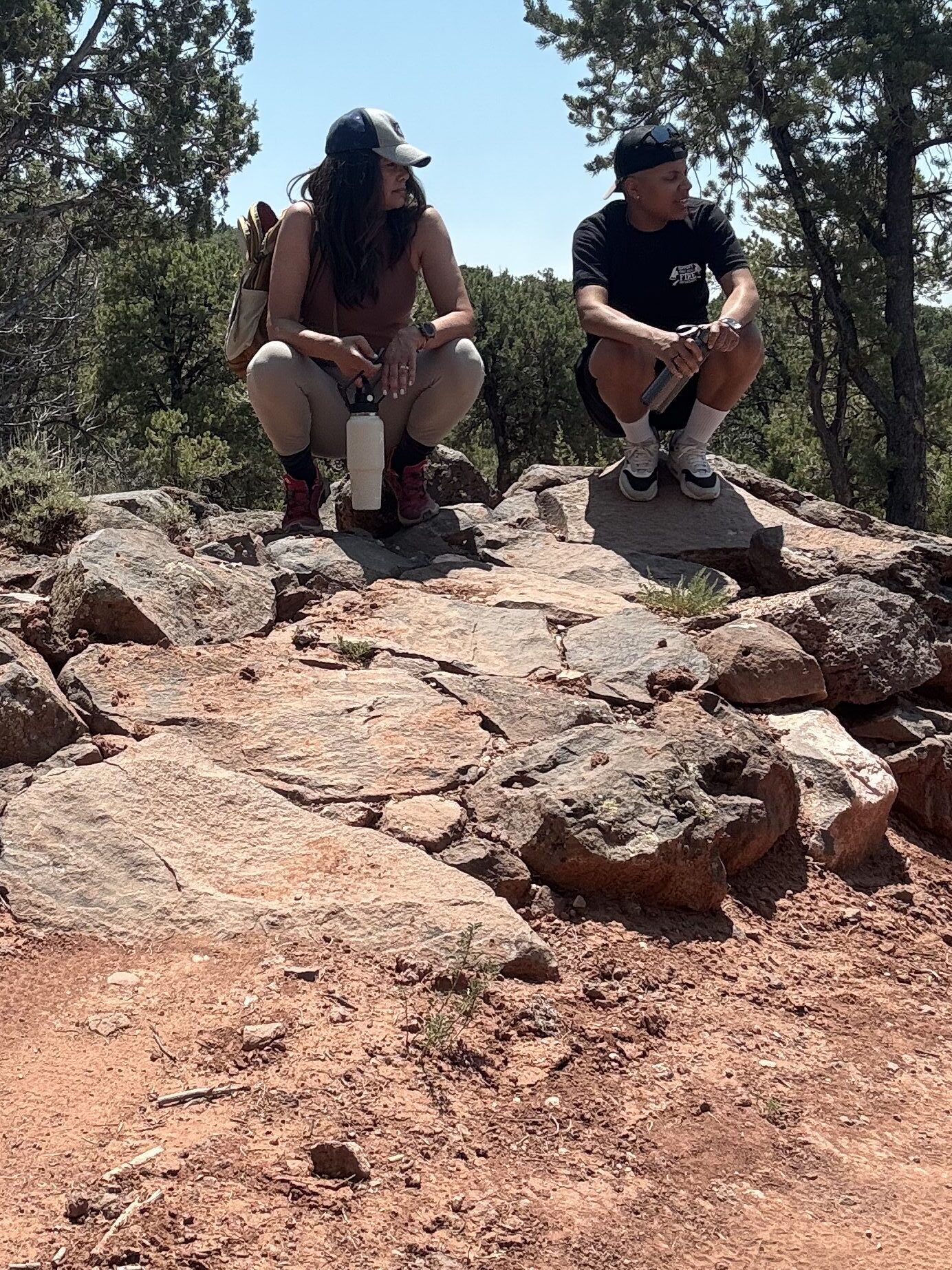 black women, mother on daughter taking a reset break while hiking in utah