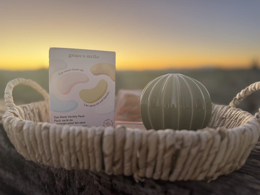 box of under-eye patches in a tray with the sunrise in the background