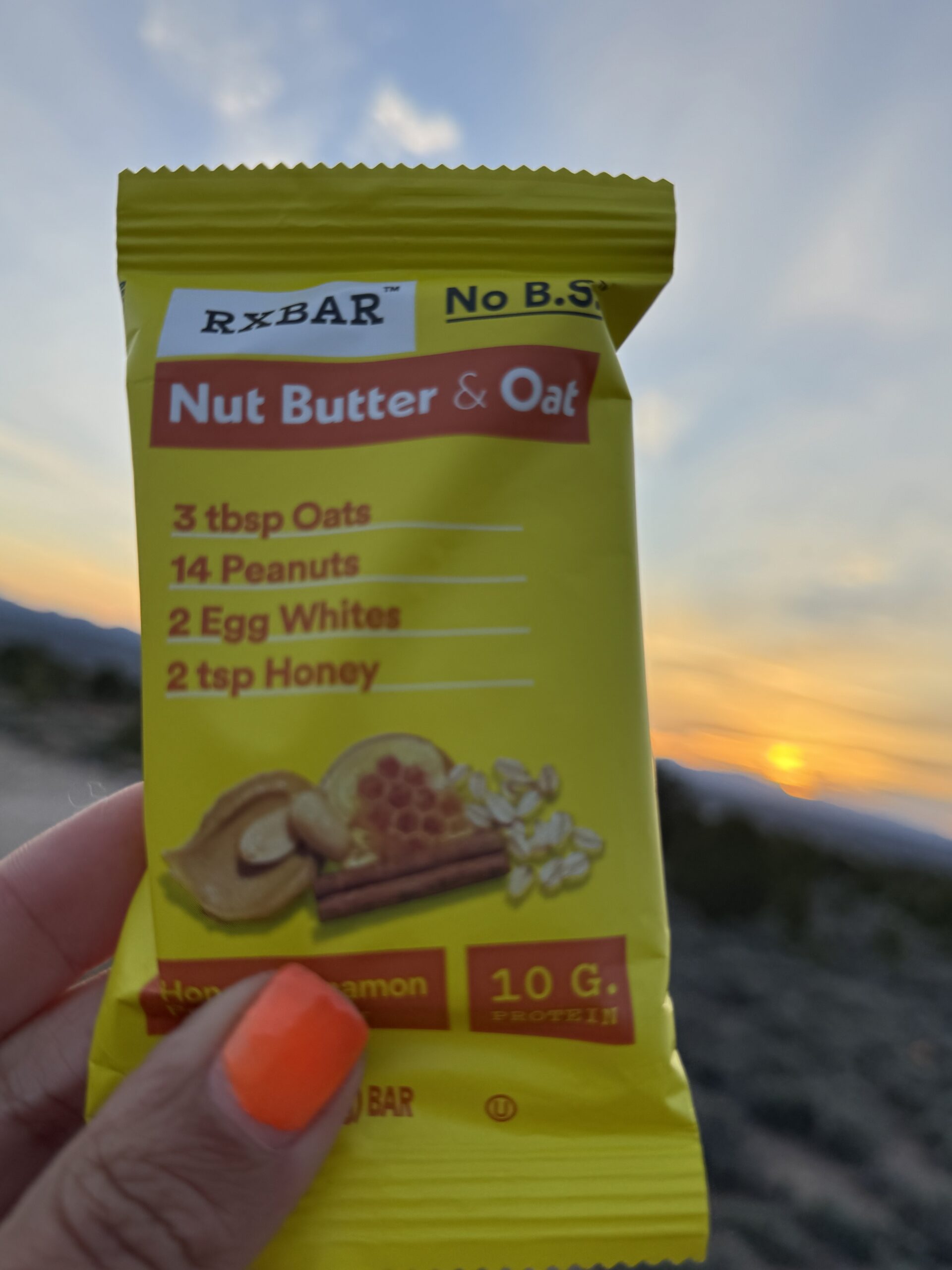 energy bar held up agains sunrise