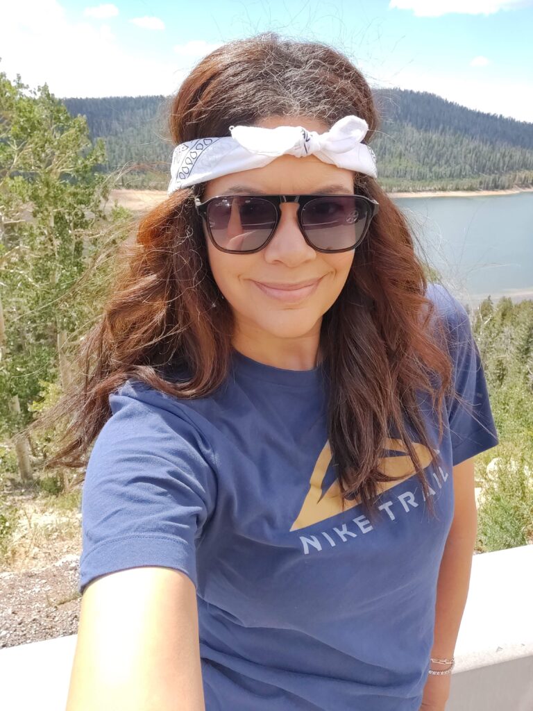 black woman wearing white bandana in front of lake in utah