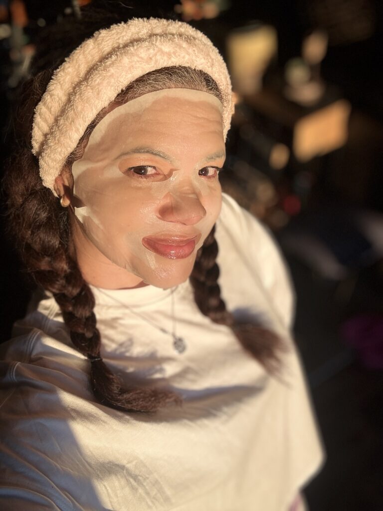 black woman wearing a hydrating face mask