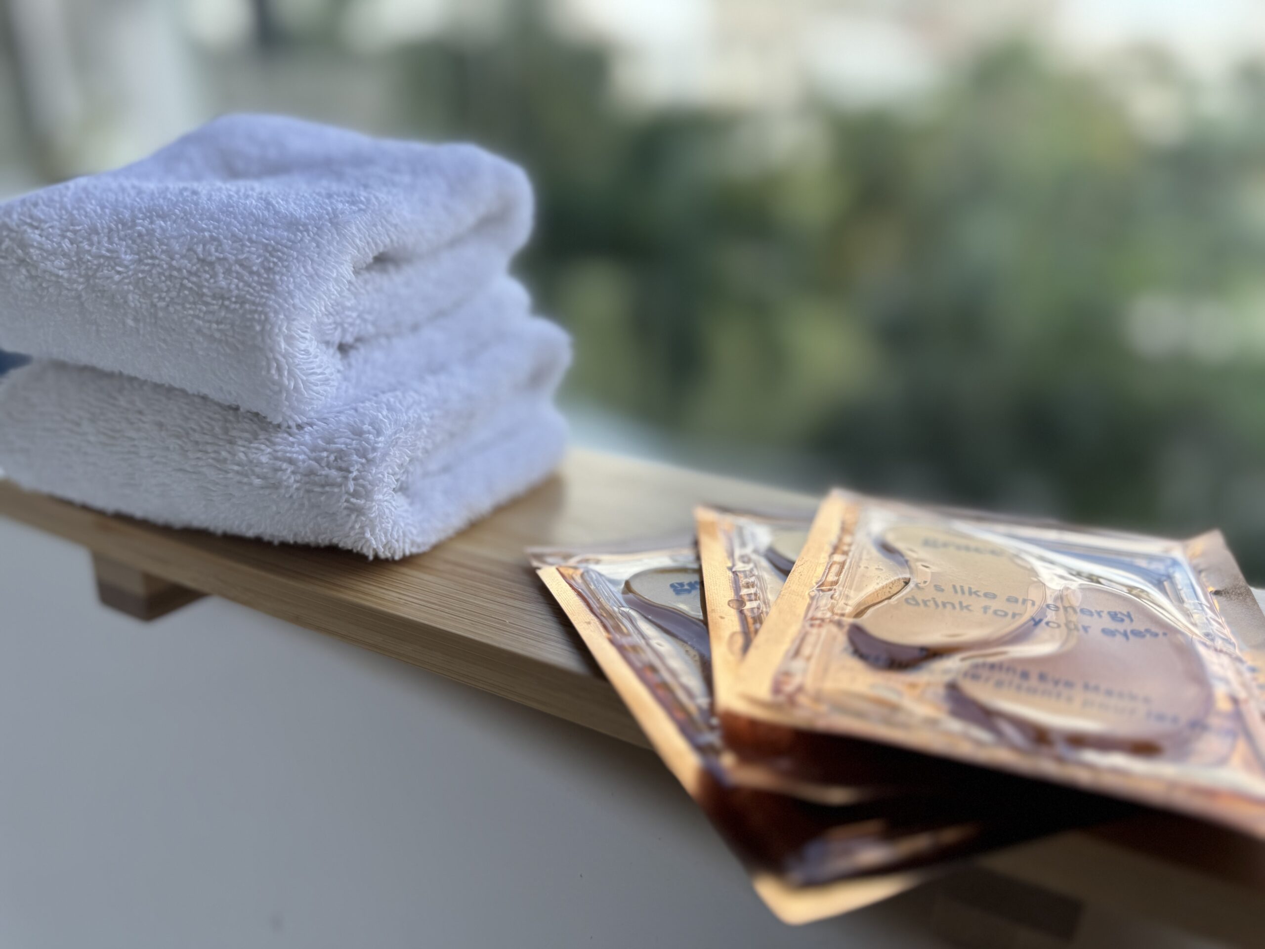 white folder hand towels on tray with eye patches balances on edge of balcony