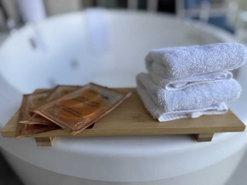 soaking tub with eye patches and white towels