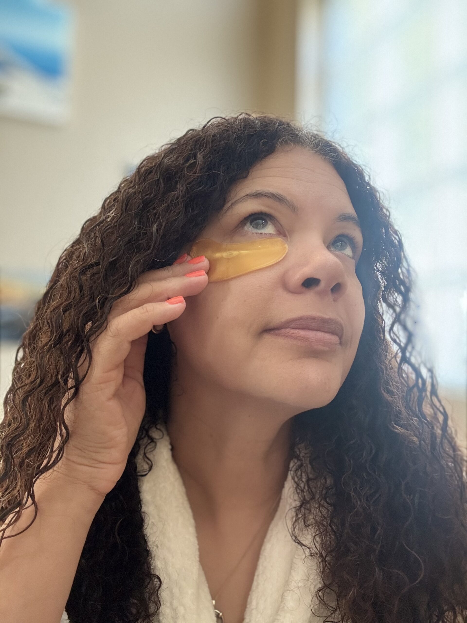 black woman applying eye masks during beauty routine