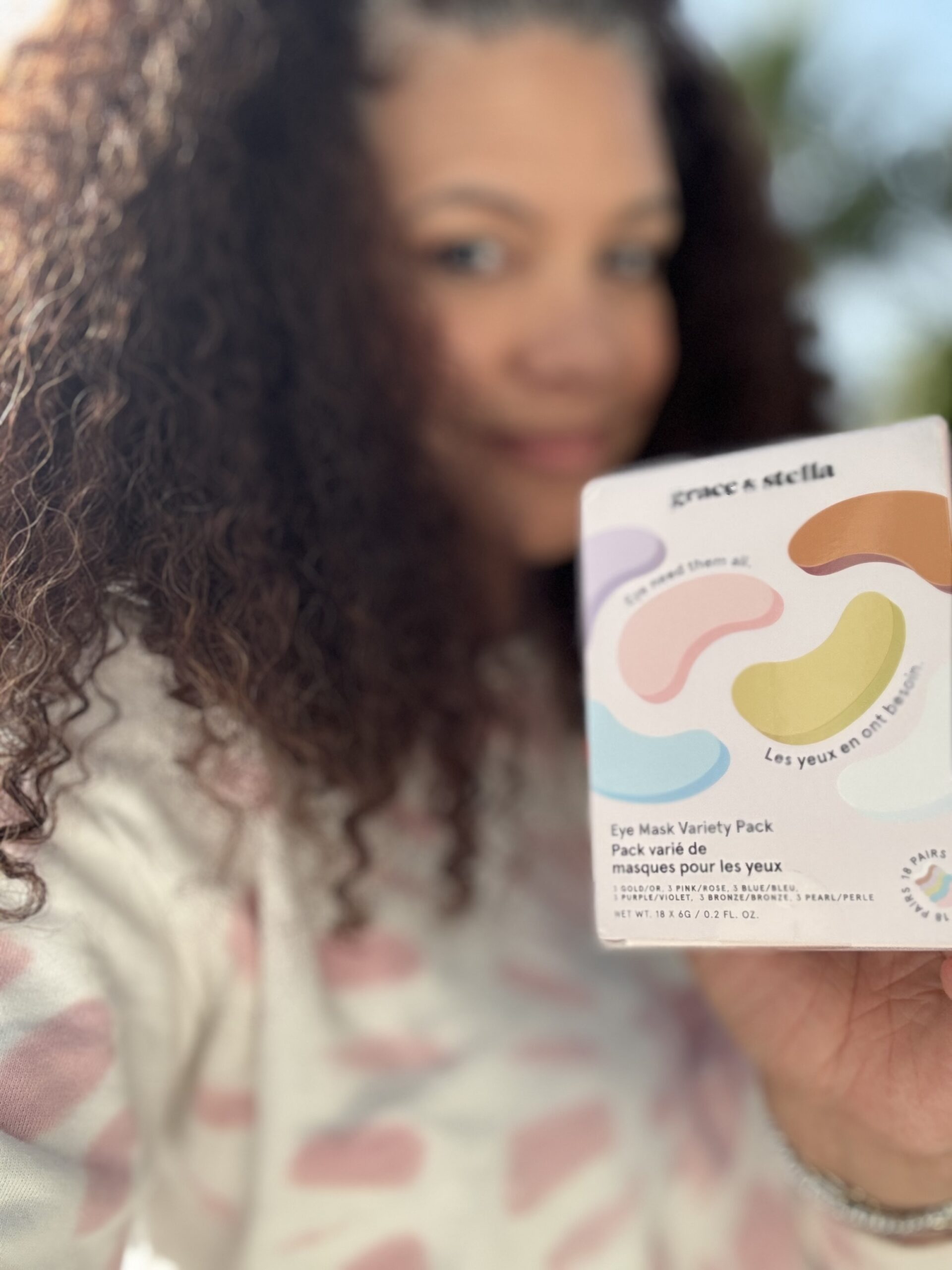 black woman holden eye patches for dark circles