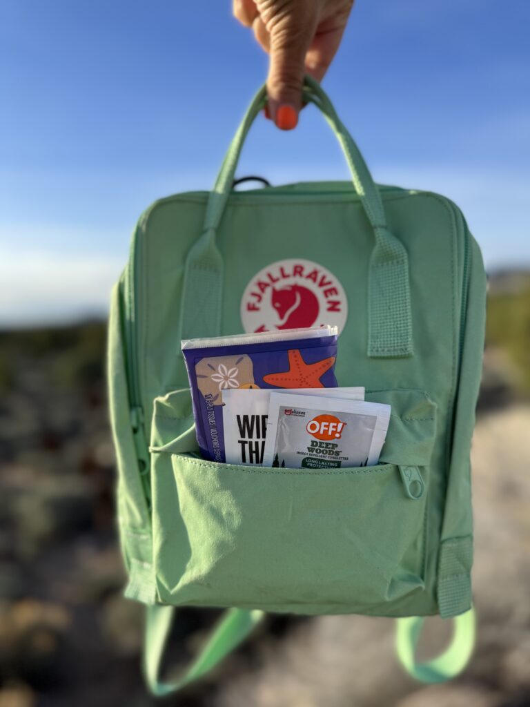greeb backback filled with hiking essential and snacks