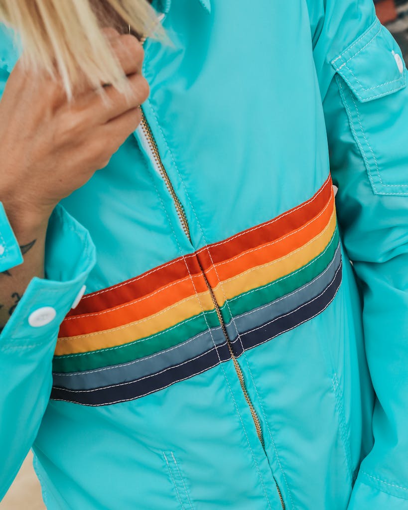 Close-up of a vibrant jacket with rainbow stripes, showcasing colorful fashion.